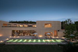 a house with a swimming pool at night at PLAN B00b7ANADOL in Xianning