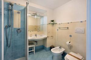 a bathroom with a sink and a toilet and a shower at La Volta Amalfi Coast in Furore +22 photos