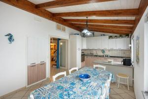 a kitchen with a table with a blue and white table cloth at La Volta Amalfi Coast in Furore