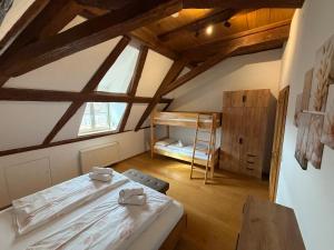 a bedroom with a bed in a room with wooden ceilings at Irseer Hof in Hagnau in Hagnau
