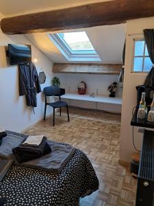 a bedroom with a bed and a window and a desk at Chambres d'hôtes chez Peggy et Eric chambre indus in Équevillon