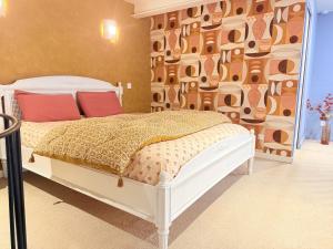 a bedroom with a bed with a wall of cow cutouts at Le Chouette Loft in Dijon