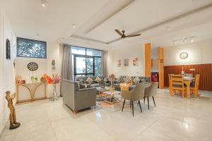 a living room with a couch and chairs and a table at Nirvana By Nest Kasauli 2 BHK Luxury Apartment Rooftop Cafe Free Parking in Kasauli