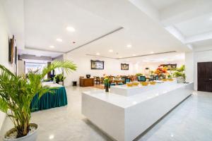 a lobby with a waiting area with plants at The Sunriver Boutique Hotel Hue in Hue