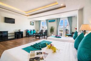 a hotel room with two beds and a living room at The Sunriver Boutique Hotel Hue in Hue +95 photos