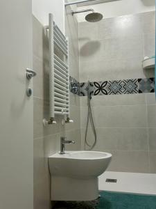 a white bathroom with a sink and a toilet at Casa Ranieri in Mattinata +4 photos