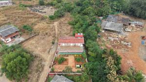 an aerial view of a house in a forest at Lucky Homes in Srīvardhan
