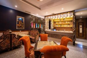 a restaurant with a table and chairs and a bar at Marugarh Resort and Spa in Jodhpur