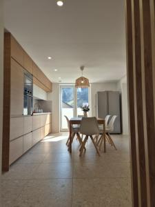 a kitchen and dining room with a table and chairs at Green River Apartment in Stahovica