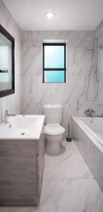 a bathroom with a sink and a toilet and a bath tub at Miaz Palace in Elim +4 photos