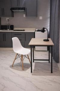 a white chair sitting next to a table in a kitchen at Miaz Palace in Elim