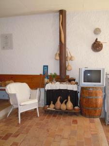 a living room with a tv and a table and a chair at Stalida Holiday Home in Stalida