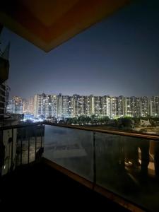 a view of a city skyline at night at Luxe Haven Stays - Luxury Studio , Premium Stay in Noida