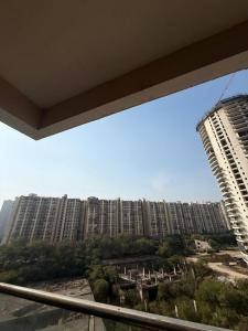 a view of a large city with tall buildings at Luxe Haven Stays - Luxury Studio , Premium Stay in Noida +8 photos