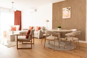 a living room with a couch and a table and chairs at ONL Apartments in Dunajská Streda +40 photos