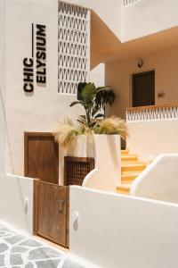 a building with a staircase and a potted plant at Chic Elysium in Naxos Chora