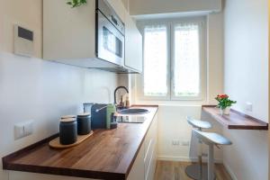 a kitchen with a wooden counter top with a sink at Colibrì in Milan +14 photos