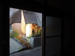 a view of a house through a window at The Asagiri Guest House in Tanabe +27 photos