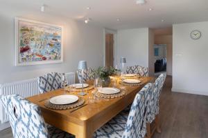 a dining room with a wooden table and chairs at Rose Cottage in Wadebridge +7 photos