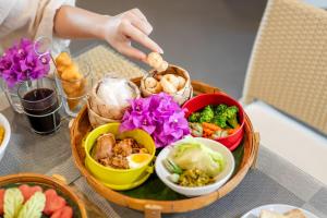 a table with a tray of food on a table at Emmaline Hotel Nan in Nan