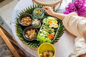 a plate of food on top of a table at Emmaline Hotel Nan in Nan