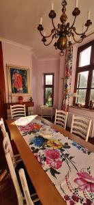 a dining room table with a floral table cloth on it at Les Tourelles in Contes +36 photos
