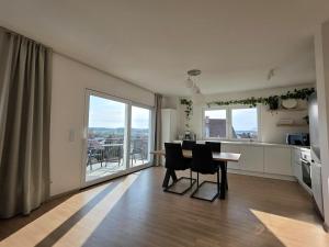 a kitchen and dining room with a table and chairs at Apartment Ilmtalblick in Pfaffenhofen an der Ilm