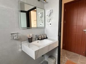 a bathroom with a white sink and a mirror at Long Bình Hotel in Dong Hoi +147 photos