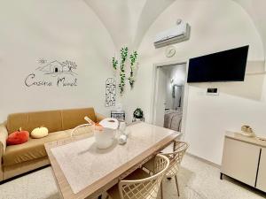 a living room with a table and a couch at Casina Mameli in Nardò