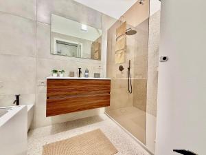 a bathroom with a sink and a shower with a mirror at Casina Mameli in Nardò