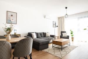 a living room with a couch and a table at ONL Apartments in Dunajská Streda