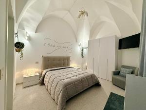 a bedroom with a bed and a chair at Casina Mameli in Nardò