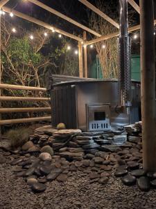a rock garden with a stove in a building at Urchins Nest in Woolacombe