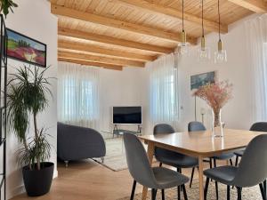 a dining room with a wooden table and chairs at Señorial Panorámico by apartamentoscatedralcamino in Burgos