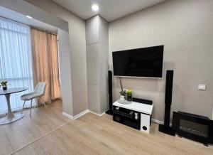 a living room with a flat screen tv on a wall at Ривер люкс Днепр in Dnipro