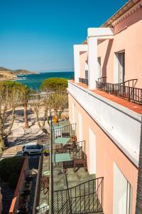 a balcony with chairs and a view of the ocean at Hotel de la plage in Banyuls-sur-Mer +33 photos