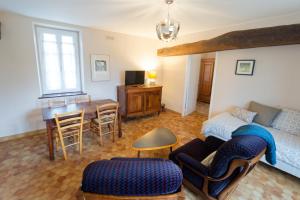 a living room with a couch and a table at La Boisselée in Saint-Dyé-sur-Loire