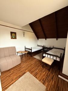 a living room with two beds and a couch at Motel M in Malacky