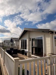 a house with a porch with a roof at Seaview Holiday Rentals - Pebble Beach in Whitstable