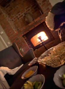 a table with plates of food and a fireplace at Ranch Johanna Top floor in Kullavik