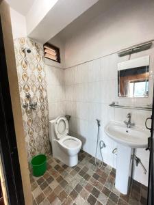 a bathroom with a toilet and a sink at Hotel Everest Lake View in Pokhara