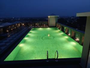 a swimming pool on top of a building at night at Hotel Grand Maspel in Dimapur