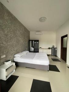 a bedroom with a large bed and a kitchen at Sea Sky Dreams in Kuta Lombok +13 photos