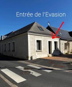 a building with a red arrow on the side of it at Love Room Evasion Jacuzzi Sauna Hamamm in Saint-Cyr-sur-Loire