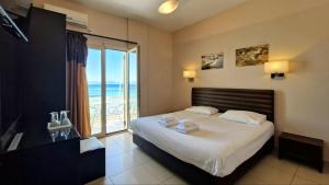 a bedroom with a bed with a view of the ocean at Plaza in Egina +32 photos