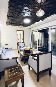 a living room with couches and a table at The S - Luxurious Stays in Mahabaleshwar