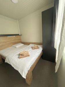 a bedroom with a bed with two towels on it at Tiny homes ŠMARNA in Ljubljana