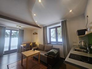 a living room with a couch and a table at Przystanek Dolina Kościeliska in Kościelisko
