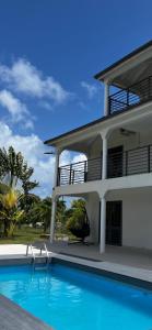 a house with a swimming pool in front of it at Korah house in Saint Philip