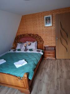 a bedroom with a large bed with a wooden headboard at A frame iris in Filioara